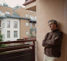 Fototapeta premium mature sad man on balcony at home