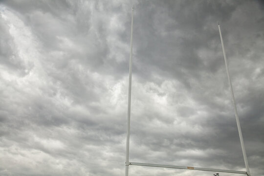 Rugby goal posts against dramatic storm sky