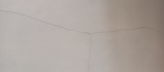 Hairline Cracks on White Plaster Wall and Ceiling Surface