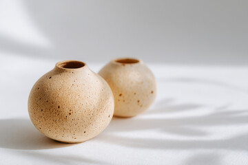 handcrafted clay pottery with intricate textures displayed on clean background