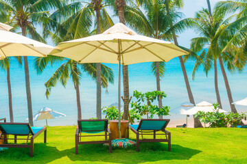 Empty hammock tied between palm trees on green grass near tropical beach, peaceful vacation spot with ocean view and relaxation vibes, perfect escape to paradise, Phu Quoc island, Vietnam