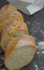 Baguette bread on black background with flour