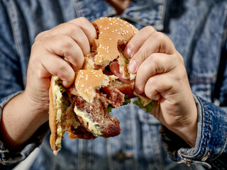 broken burger in human hands