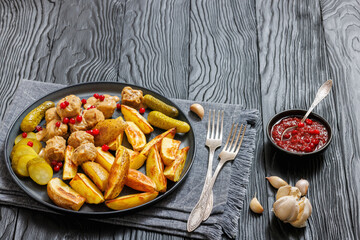 meatballs, potatoes, pickles, berries on a plate