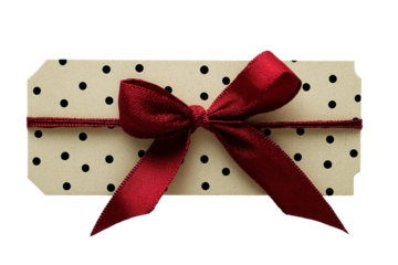 Gift box with red ribbon on a white background featuring black polka dots, perfect for celebrations and special occasions like birthdays or holidays