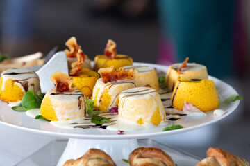 Delicious savory pumpkin flan with crispy bacon and balsamic glaze on a white plate
