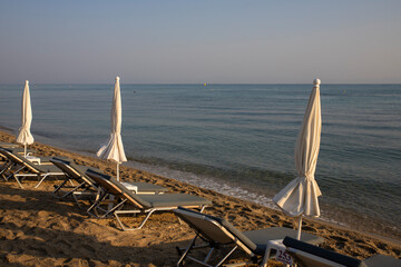 Beach with sun beds and umbrellas near the sea