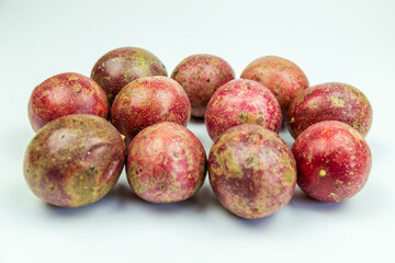 A pile of passion fruits on a white background