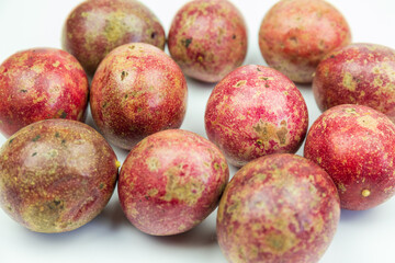A pile of passion fruits on a white background