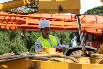Construction Worker Reviewing Documents on Site