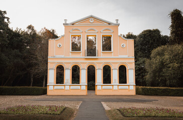 Fototapeta premium Replica of a German house with a neoclassical facade, with symmetrical columns and arches located in a square in the city of Curitiba, Brazil.