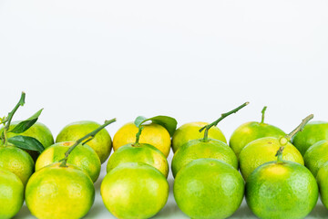 Fresh fruits and oranges neatly arranged on a white background