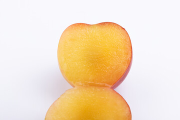 Fresh red plums cut in half