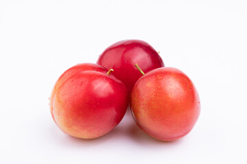 Three fresh red plums