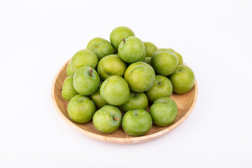 Fresh plums in the wooden plate