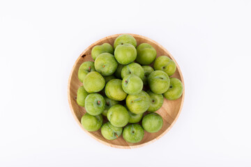 Fresh plums in the wooden plate