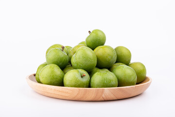 Fresh plums in the wooden plate