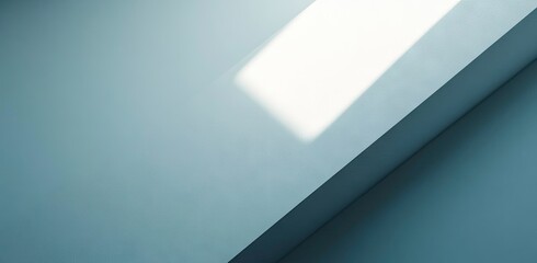 Obraz premium Light striking a muted blue surface.