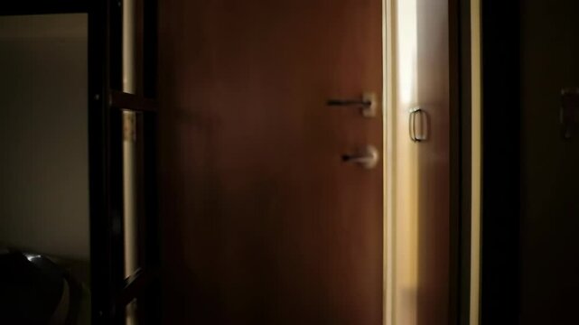 Dorm room door slowly closing in a dimly lit environment  