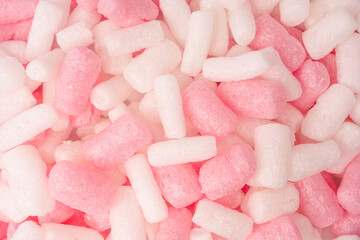 Pink and white box filler as a background. Top view.