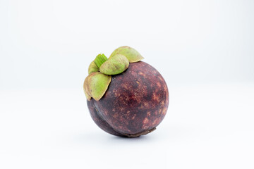 A mangosteen fruit on a white background