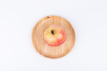 Fresh pomegranates in the wooden plate