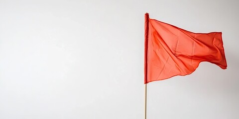 Single red fabric flag on pole, isolated on clean white background, close-up view