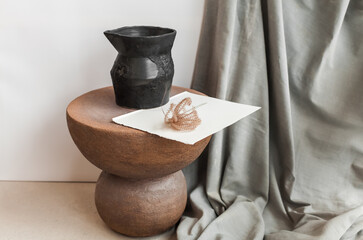 Minimalist still life of handmade ceramic decor in earthy tones. Unique pottery pieces for interior styling: vases, lamps, mirror frames, and home accessories with natural textures