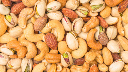 Close-up of roasted nuts, including cashews, almonds, and pistachios.