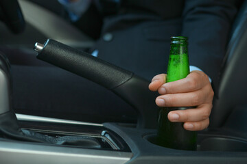 Drinking beer while driving is illegal and can cause serious accidents.