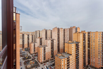 Multi-story residential buildings in a dense development, top view of courtyards and parking lots. Urban landscape.