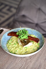 Top View of Pea Risotto with Cod and Crispy Bacon – Spring-Inspired Restaurant Dish