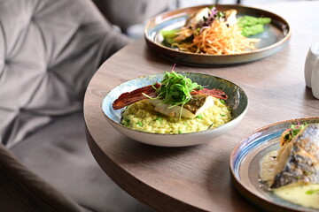 Top View of Pea Risotto with Cod and Crispy Bacon – Spring-Inspired Restaurant Dish