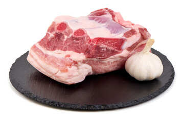 Raw Pork Chop with Garlic on Slate Plate, Isolated on White Background.