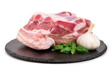 Raw Pork Chop with Garlic on Slate Plate, Isolated on White Background.