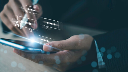 Hand holding smartphone with AI chatbot message icons, representing artificial intelligence, digital communication, and modern technology.