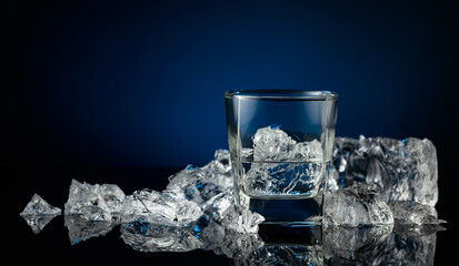 Crystal clear vodka or gin in a glass with ice.