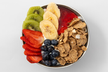 Healthy breakfast bowl - berries, muesli, fruits. Healthy detox morning meal. Whole grain flakes and fresh fruits.