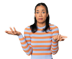 Young Filipina woman doubting and shrugging shoulders in questioning gesture.