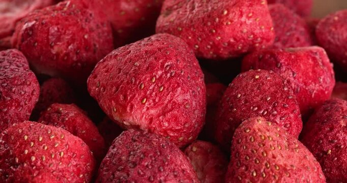 Plate with freeze-dried strawberries in a close-up macro. Close-up footage on the rotating table.