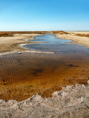 A watercourse of varying degrees of salinity from a hypersalted lake. The bitter-salty river. A...