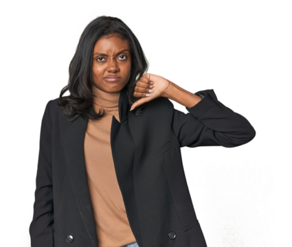 Young Indian woman in business suit showing thumb down, disappointment concept.