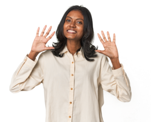 Portrait of a young Indian woman showing number ten with hands.