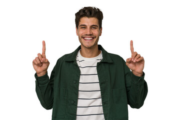 Young handsome caucasian man isolated on white background indicates with both fore fingers up showing a blank space.
