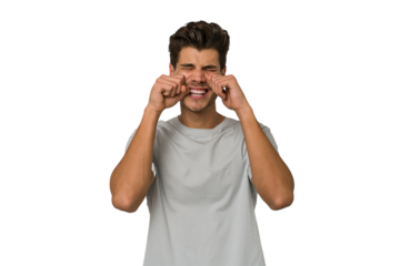 Young handsome caucasian man isolated on white background whining and crying disconsolately.