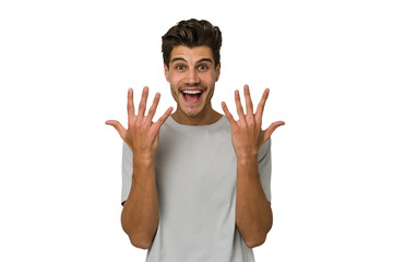 Young handsome caucasian man isolated on white background showing number ten with hands.