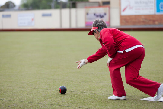 Older woman delivering a lawn bowl