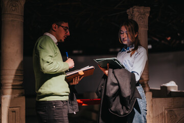 People engage in discussion while examining documents in a museum setting, conveying themes of...
