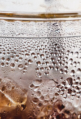 Iced Beverage with Condensation: A close-up shot of a glass of iced beverage, the condensation forming a beautiful pattern on the exterior of the glass.