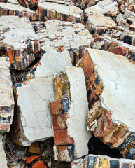 Winter strong fierce storm (cyclone) destroyed a stone house on a sandy beach. The wall fell under...